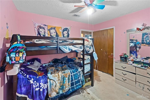 bedroom with a textured ceiling and ceiling fan