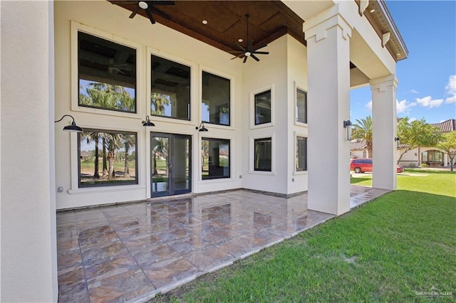 3910 La Hacienda St, Weslaco, TX 78596 - property entrance with stucco siding, a lawn, ceiling fan, and a patio area