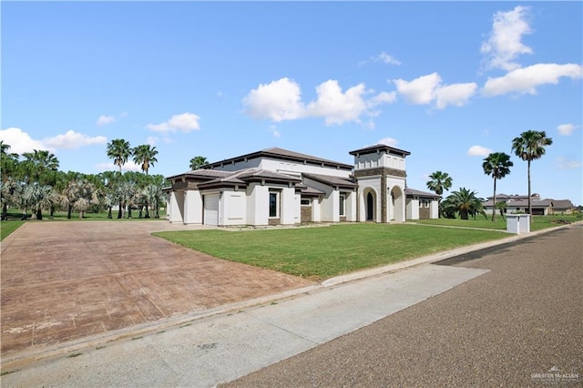 3910 La Hacienda St, Weslaco, TX 78596 - view of front of home with a front lawn, decorative driveway, and a garage