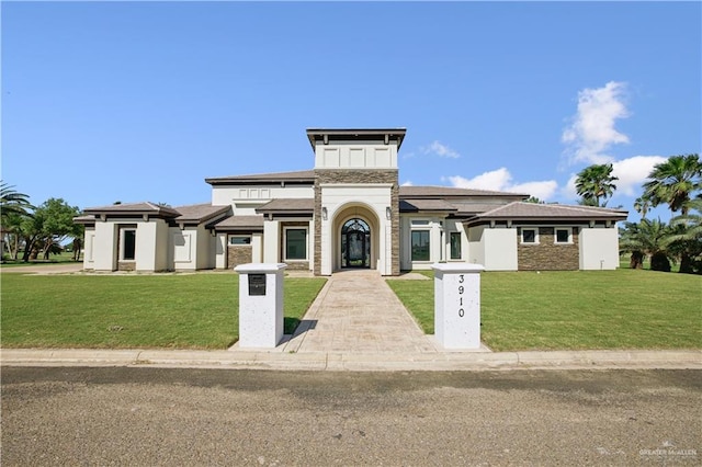 3910 La Hacienda St, Weslaco, TX 78596 - view of front of house featuring stone siding and a front lawn