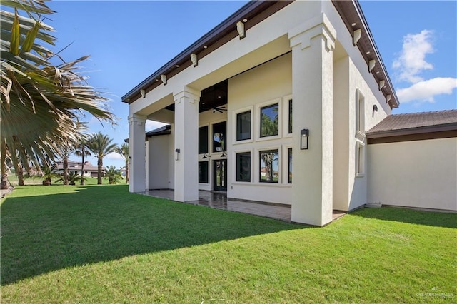 3910 La Hacienda St, Weslaco, TX 78596 - back of property featuring a ceiling fan, stucco siding, and a lawn