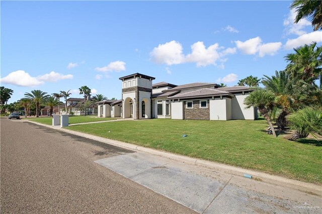3910 La Hacienda St, Weslaco, TX 78596 - view of front of property featuring stone siding and a front yard