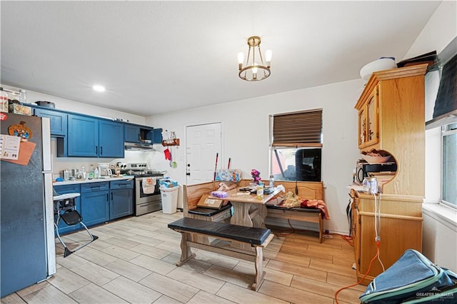 kitchen featuring blue cabinetry, a wealth of natural light, pendant lighting, and stainless steel appliances