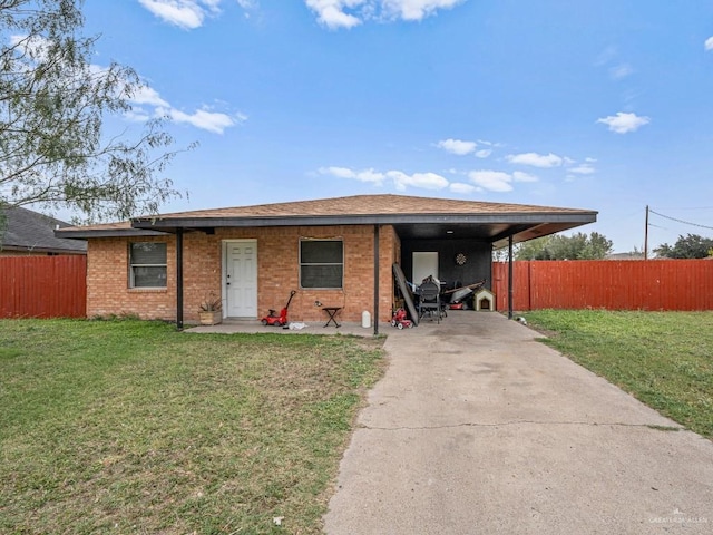 view of front of property with a front yard and a carport