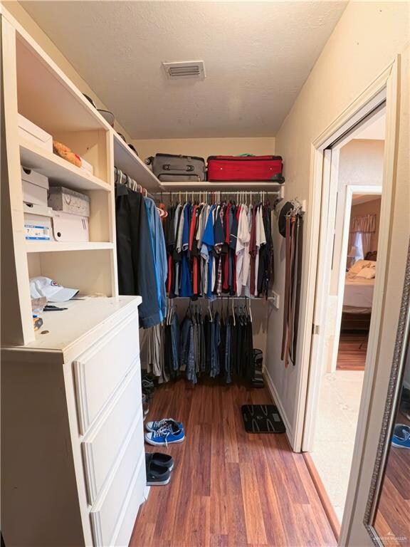 spacious closet featuring hardwood / wood-style flooring