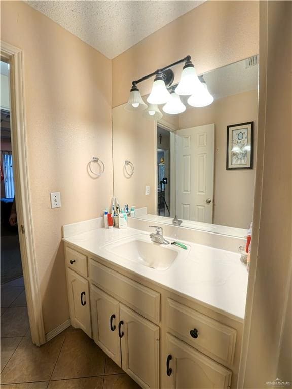 bathroom featuring tile patterned floors, vanity, and a textured ceiling