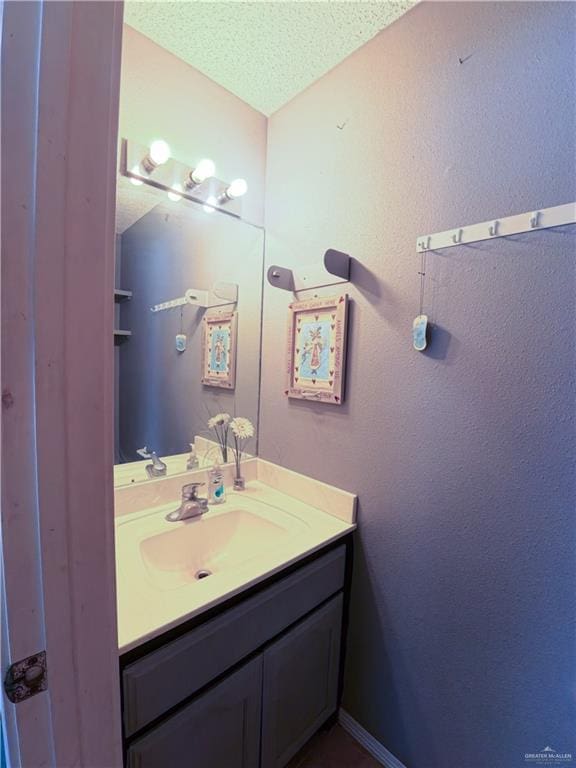 bathroom with vanity and a textured ceiling