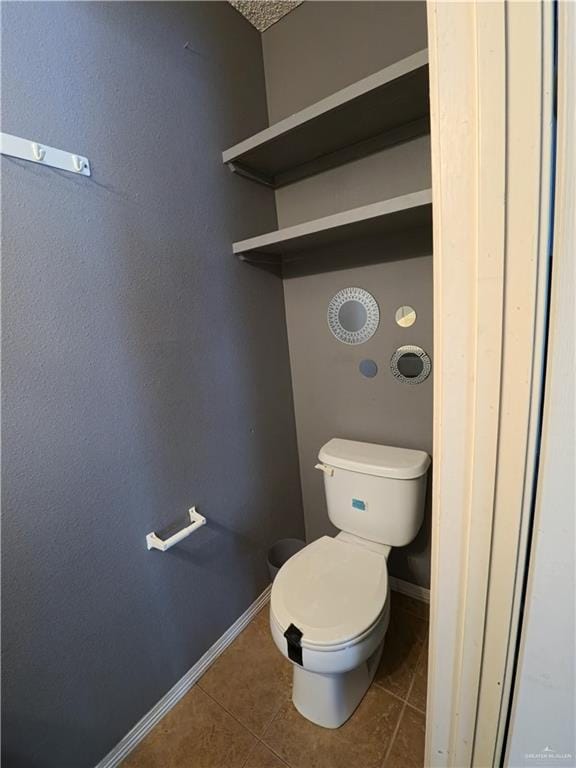 bathroom with tile patterned floors and toilet