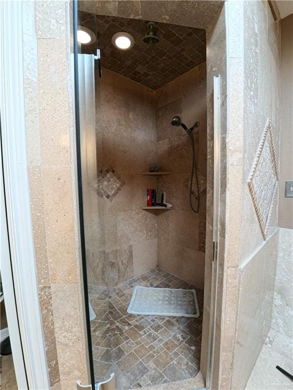 bathroom with a tile shower