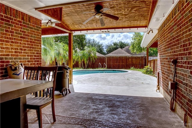 view of patio with a fenced in pool and ceiling fan