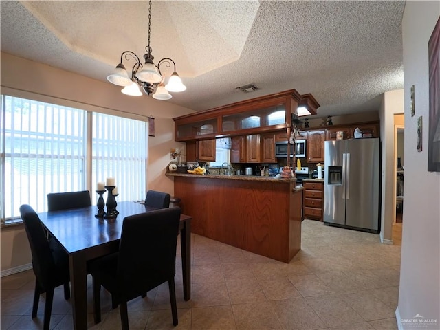 dining room featuring light tile patterned floors, a textured ceiling, and an inviting chandelier