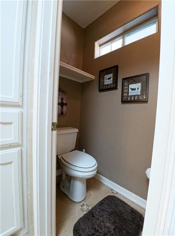 bathroom featuring tile patterned floors and toilet