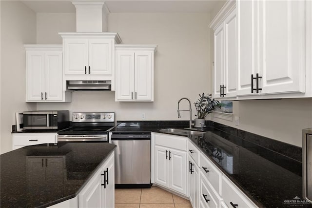 622 Comedy Ln, Edinburg, TX 78542 - kitchen featuring stainless steel appliances, a sink, under cabinet range hood, white cabinets, and dark stone countertops