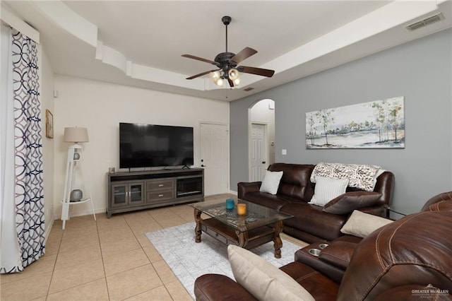 622 Comedy Ln, Edinburg, TX 78542 - living room with arched walkways, a tray ceiling, light tile patterned floors, a ceiling fan, and baseboards