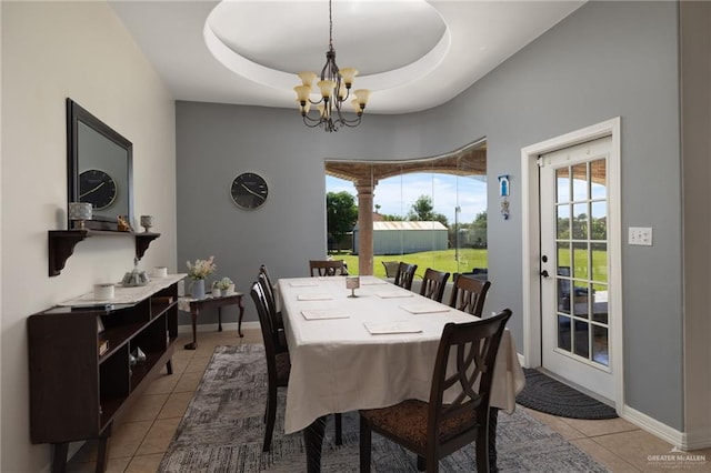 622 Comedy Ln, Edinburg, TX 78542 - dining area with a chandelier, light tile patterned floors, a tray ceiling, and baseboards