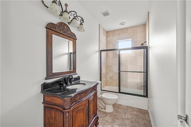 bathroom featuring tile patterned flooring, visible vents, bath / shower combo with glass door, toilet, and vanity