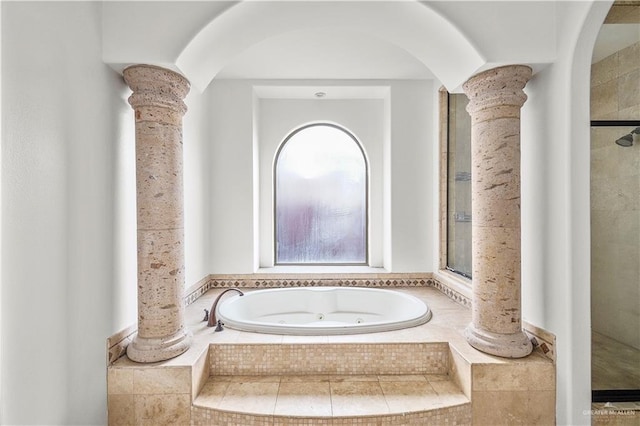 full bathroom featuring a whirlpool tub and ornate columns