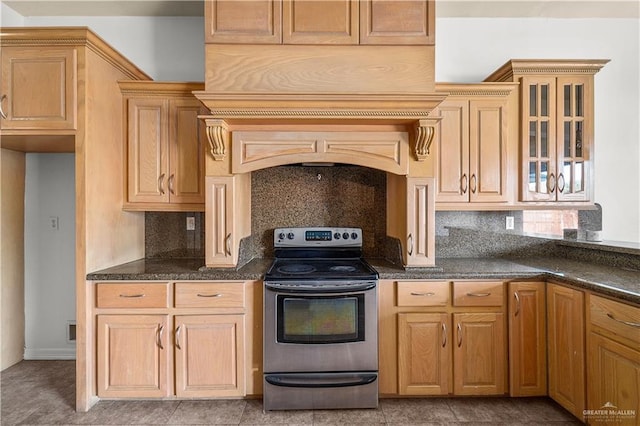 kitchen with glass insert cabinets, tasteful backsplash, and stainless steel range with electric cooktop