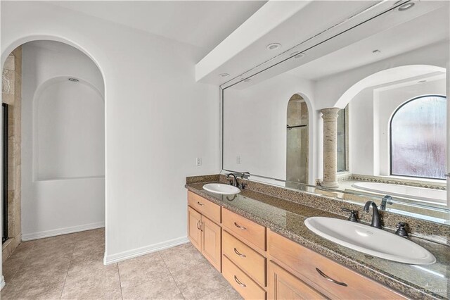 full bath featuring tile patterned floors, a shower with shower door, and a sink