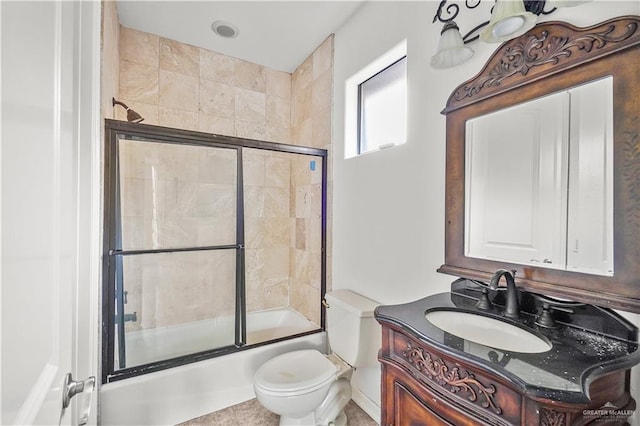 full bathroom with vanity, toilet, and shower / bath combination with glass door