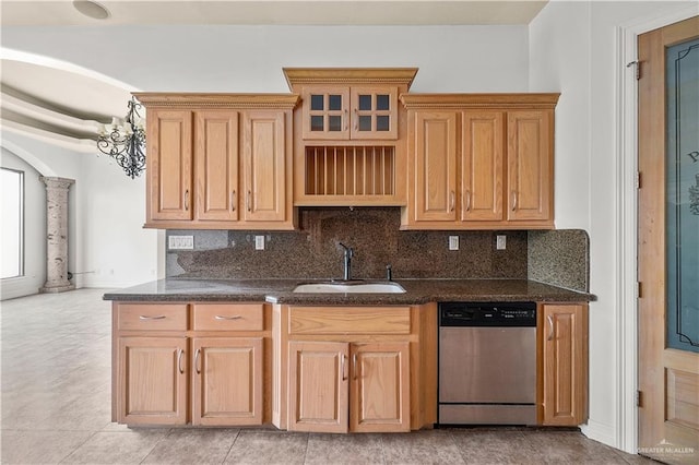 kitchen with a sink, tasteful backsplash, stainless steel dishwasher, and ornate columns