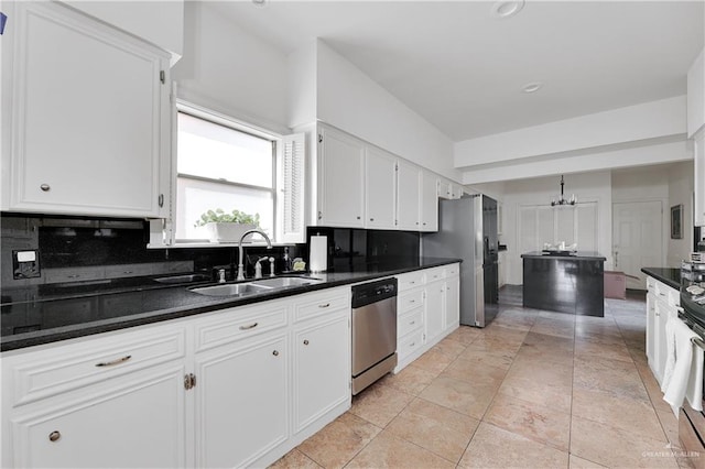 kitchen with white cabinets, appliances with stainless steel finishes, backsplash, and sink