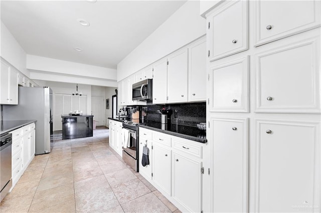 kitchen featuring white cabinets, appliances with stainless steel finishes, decorative backsplash, and light tile patterned flooring