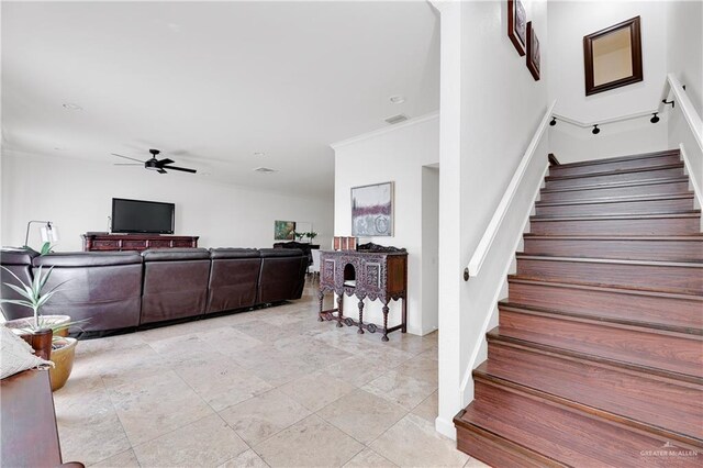 staircase featuring ceiling fan