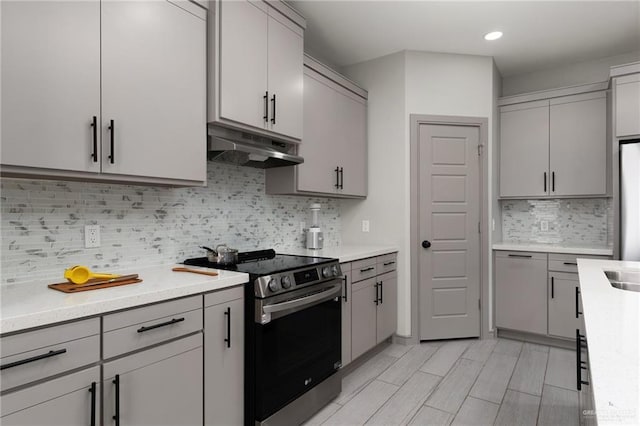 323 Uva Ln, Brownsville, TX 78521 - kitchen featuring under cabinet range hood, light countertops, and stainless steel electric stove