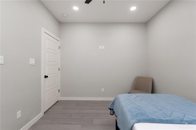 323 Uva Ln, Brownsville, TX 78521 - bedroom with baseboards, wood finished floors, and recessed lighting