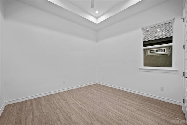 unfurnished room with baseboards, wood finished floors, and recessed lighting