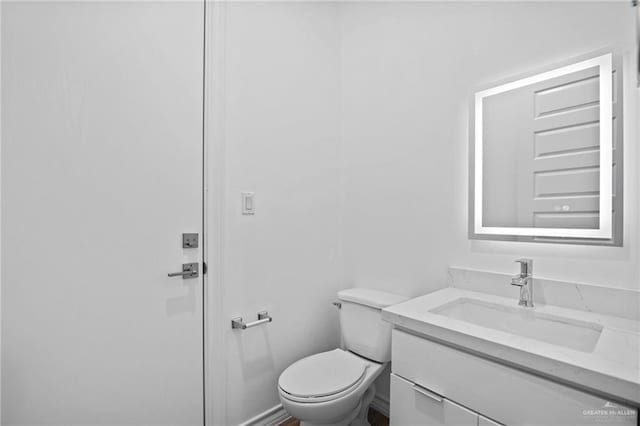 bathroom featuring toilet and vanity