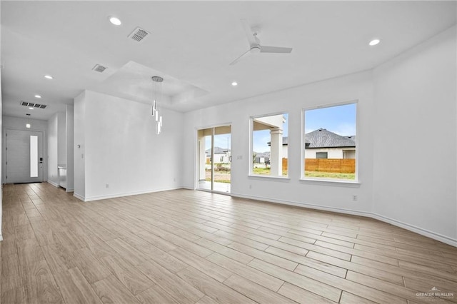 spare room with light wood-type flooring, visible vents, a ceiling fan, and recessed lighting