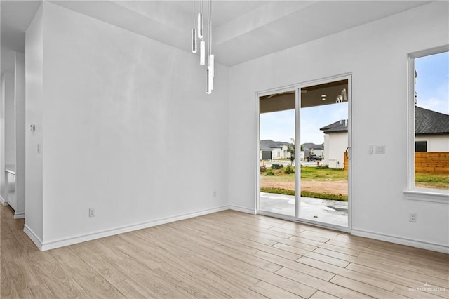 interior space with baseboards and wood finished floors