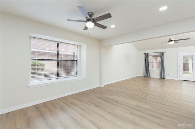 spare room with ceiling fan and light wood-type flooring