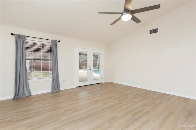 unfurnished room featuring lofted ceiling, light hardwood / wood-style flooring, french doors, and ceiling fan