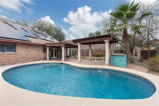 view of swimming pool featuring a pergola and a patio