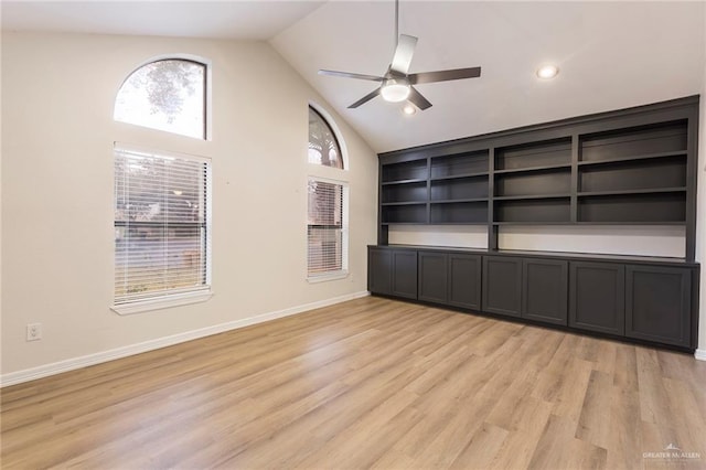 interior space with ceiling fan, high vaulted ceiling, light wood-type flooring, and built in shelves