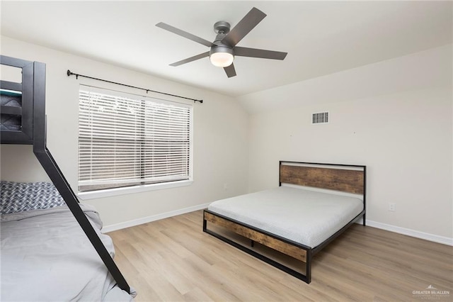 bedroom featuring lofted ceiling, ceiling fan, and light hardwood / wood-style flooring