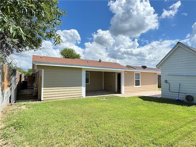 back of house with ac unit, a patio area, fence, and a lawn