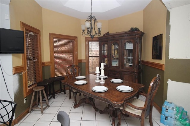 tiled dining space featuring a chandelier