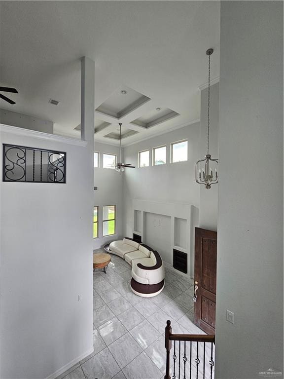 bathroom with visible vents, a high ceiling, and ceiling fan with notable chandelier