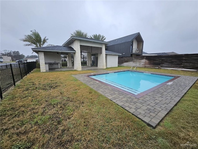 view of pool featuring a fenced backyard, a ceiling fan, a yard, a fenced in pool, and a patio area