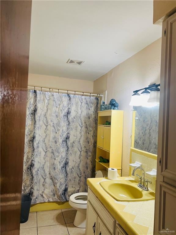 bathroom with tile patterned flooring, vanity, toilet, and a shower with curtain