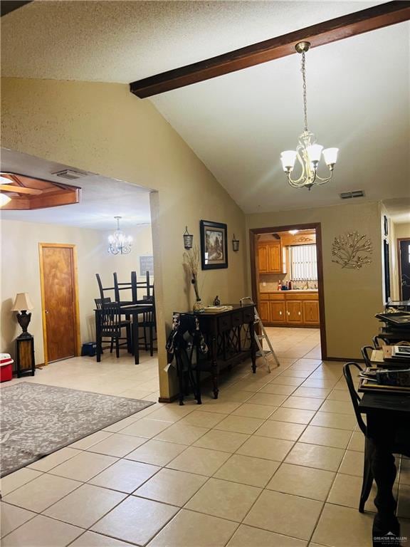 dining room featuring lofted ceiling with beams, light tile patterned floors, a textured ceiling, and an inviting chandelier