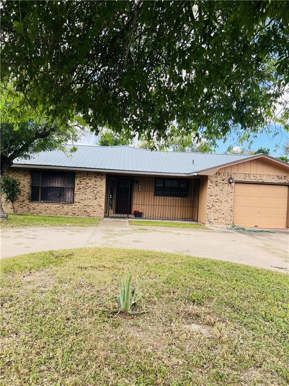 single story home with a front yard and a garage