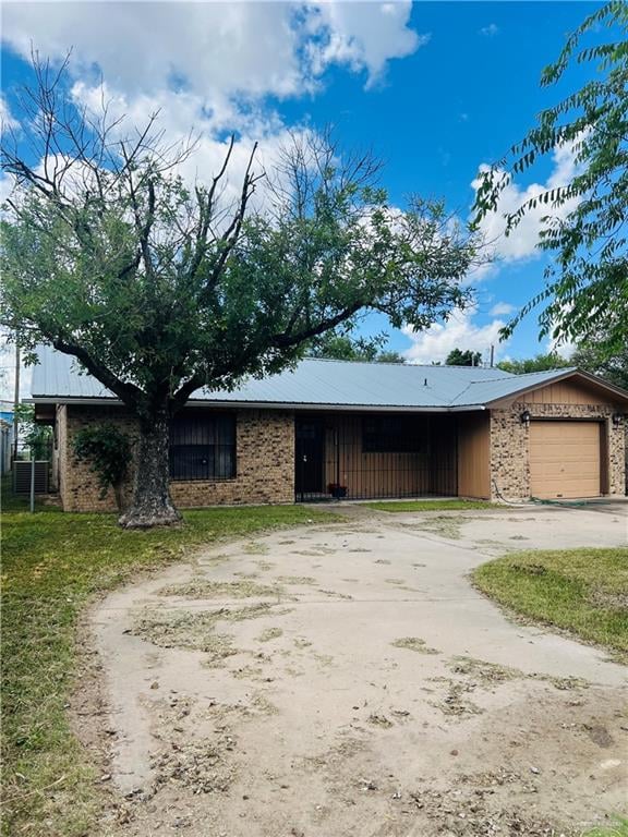 ranch-style home with a garage and a front lawn