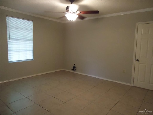 tiled empty room featuring ceiling fan and ornamental molding