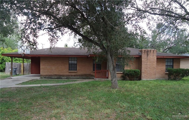 ranch-style home featuring a front yard and a carport