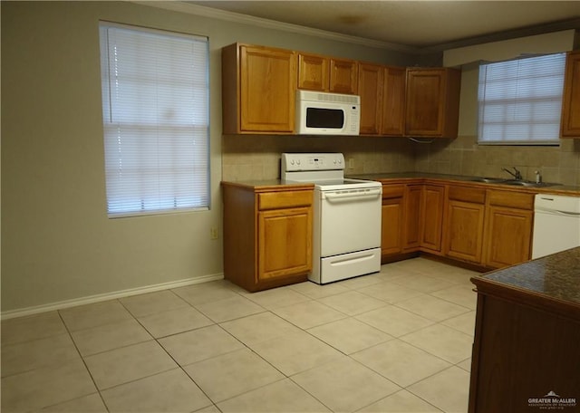 kitchen featuring tasteful backsplash, ornamental molding, white appliances, sink, and light tile patterned floors